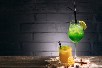 green cold cocktails with lime, orange and straws  © goami