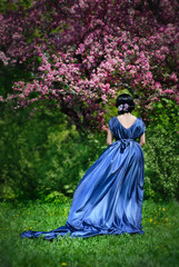 Fototapeta na wymiar girl in the garden and cherry blossoms