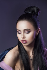 Fototapeta premium Gorgeous brunette with make up and hairstyle