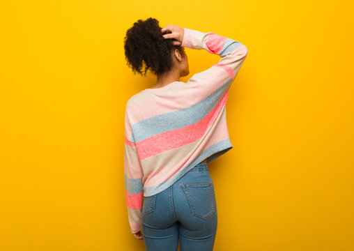 Young Black African American Girl With Blue Eyes From Behind Thinking About Something