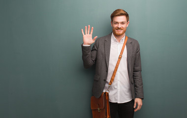 Young redhead business man showing number five