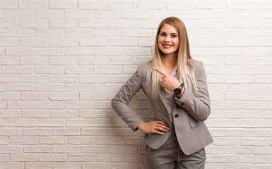 Young russian business woman smiling and pointing to the side