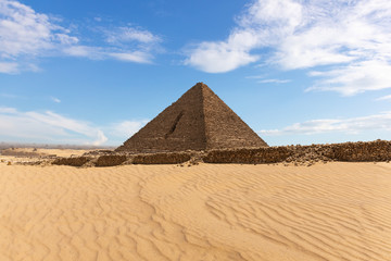 Fototapeta na wymiar Beautiful view on the Pyramid of Menkaure in the desert of Giza