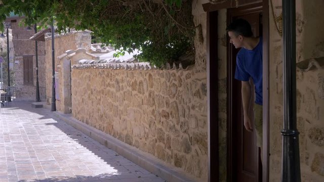 Young man comes out from the house