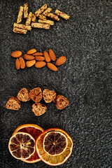 Obraz na płótnie Canvas Healthy snacks - variety oat granola bar, rice crips, almond, dried orange