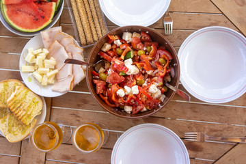 Traditional greek salad on table outside