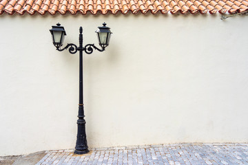 street electric lamp post at white wall