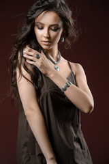 Fototapeta premium Elegant silver accessory on woman. Necklace on neck, earrings and the ring.
