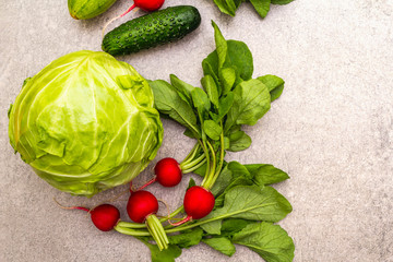 Assortment fresh green organic vegetables. Food cooking stone background. Healthy vegetarian (vegan) eating concept, close up, top view.