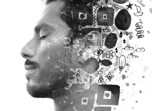 Paintography. Double exposure of an attractive male model combined with hand drawn ink paintings with geometry, symbols and a hidden message, black and white