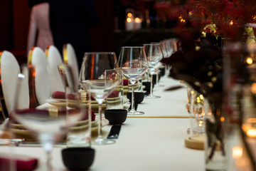 glass glasses standing in a row on a served table in the evening