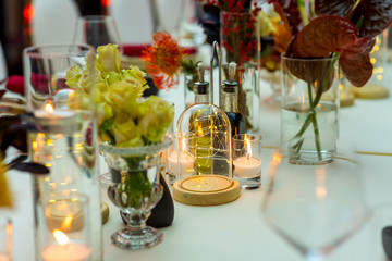 electric and natural candles and glass at the table setting