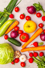 Assortment fresh organic vegetables. Food cooking stone background. Healthy vegetarian (vegan) eating concept, close up, top view, flat lay.