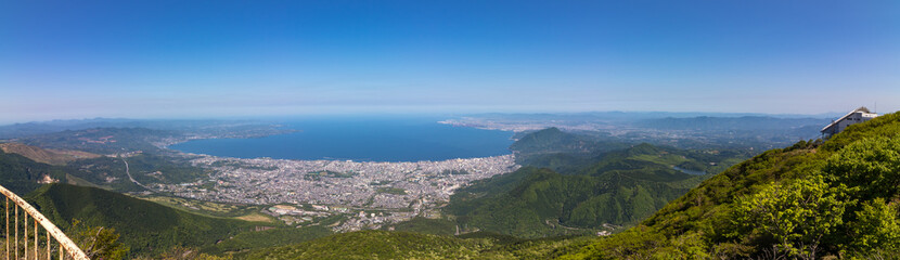 Panoramic view on Beppu City and Bay, between Mountains of Kyushu and green Landscape in the foreground from mount Tsurumi. Beppu, Oita Prefecture, Japan, Asia.