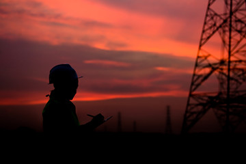 Silhouette of asian engineer working on sunset,Thailand people work on sunset