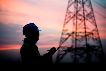 Silhouette of asian engineer working on sunset,Thailand people work on sunset