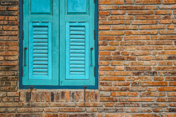 blue window brick wall exterior