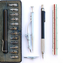 intage classic drafting drawing tool set: compass, rule, mechanical pencil and technical pen zenital view over white background