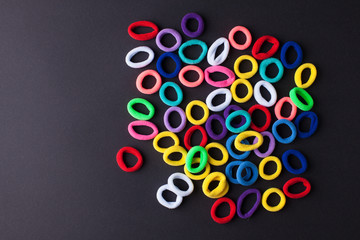 Photo with a lot of randomly lying multicolored hair elastics