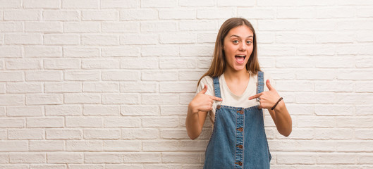 Young hipster woman surprised, feels successful and prosperous