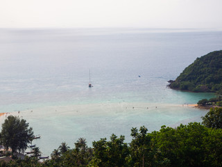 White yacht floating in the turquoise sea to the island with clouds. Koh Phangan. Thailand.	