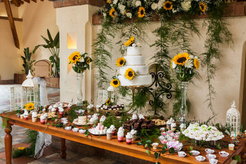 table with cake, sweets and desserts for the reception of weddings and parties