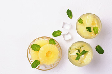Infused water with pineapple and mint on whit background.