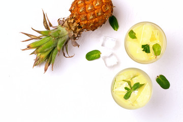 Infused water with pineapple and mint on whit background.