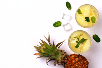 Infused water with pineapple and mint on whit background.