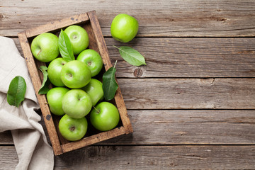 Green apples in wooden box