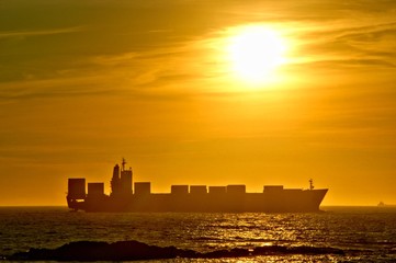Sunset with a ship cargo in Portugal