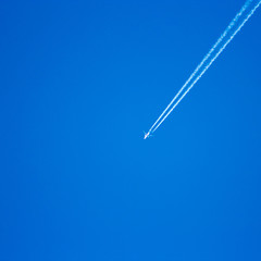 plane streaks on a blue sky in Poland