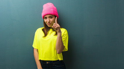 Young modern woman showing number one