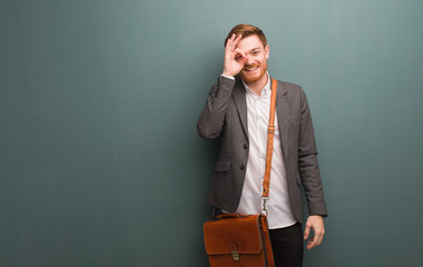 Young redhead business man confident doing ok gesture on eye