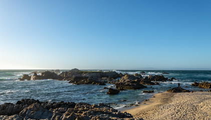 Fototapeta na wymiar California coastline views of ocean cliffs rocks and trees along the Monterey Ca. shore on a beautiful spring day 