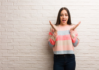 Young modern woman celebrating a victory or success