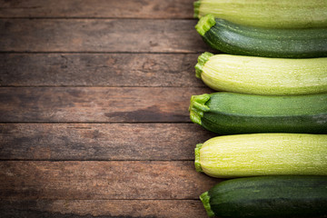 Fresh organic zucchini on the wooden table