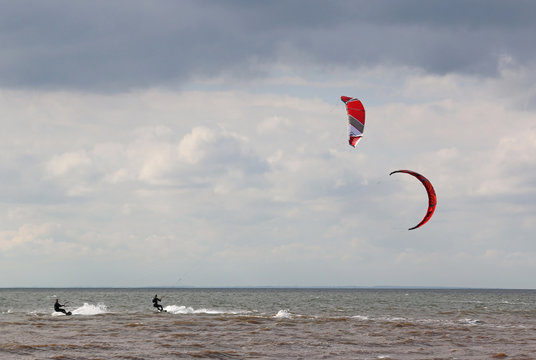 kitesurfers riding on the sea