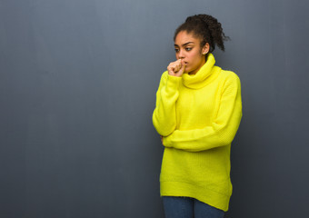 Young black woman coughing, sick due a virus or infection