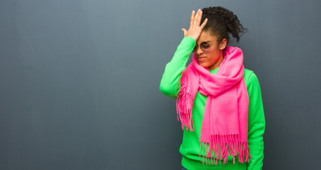 Young african american girl with blue eyes forgetful, realize something