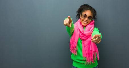 Young african american girl with blue eyes cheerful and smiling