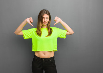 Young cool russian girl pointing fingers, example to follow