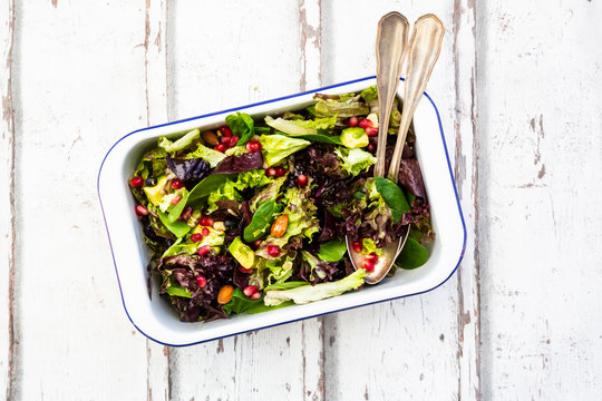 Detox salad bowl with avocado, pomegranate seeds, roasted soybeans, sunflower seeds and nuts