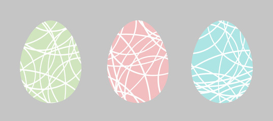 Pastel easter eggs with white patterns. On grey background