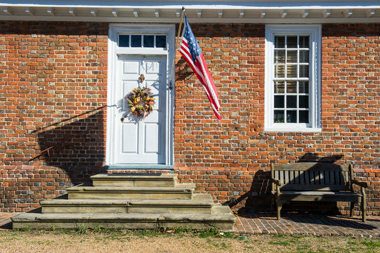 USA, Virginia, House entrance in historical Yorktown, American flag