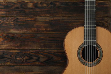 Fototapeta na wymiar Beautiful six - string classic guitar on wooden background, space for text