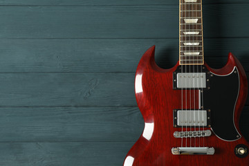 Fototapeta na wymiar Beautiful six - string electric guitar on wooden background, space for text