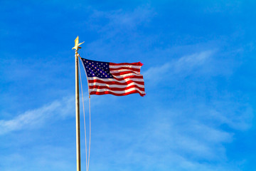 United States Flag Waving with Background of Blue Sky