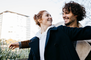 Happy couple in the city facing each other