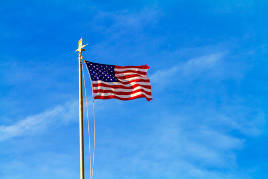 United States Flag Waving with Background of Blue Sky